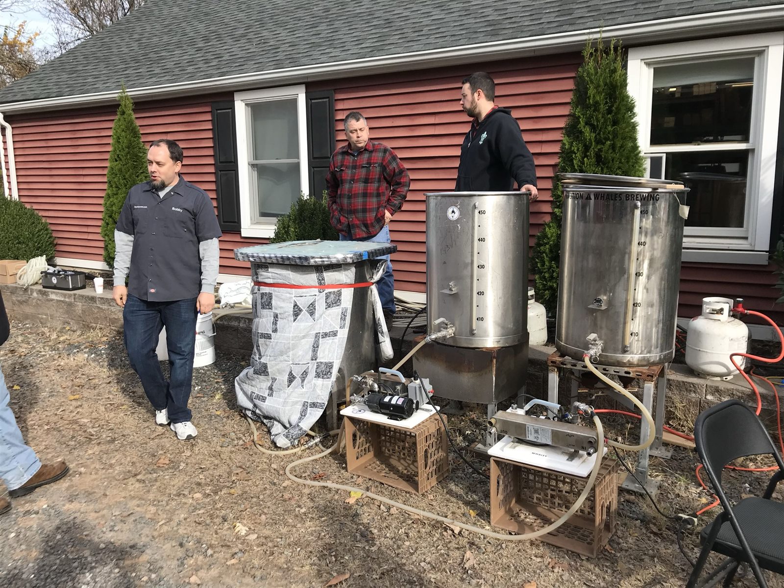 Brewers and large brewing kettles outside BrewHardware